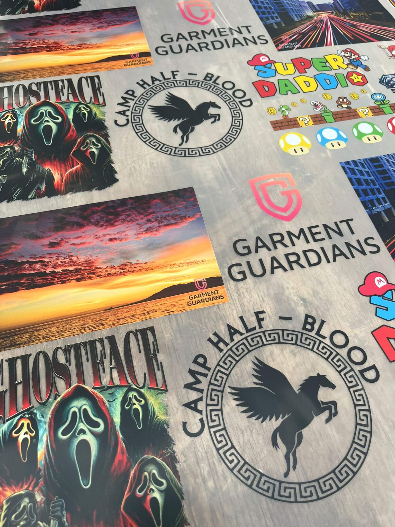 High quality DTF gang sheet with vibrant designs, featuring Ghostface, Camp Half-Blood, and Garment Guardians logo, Leicester UK.